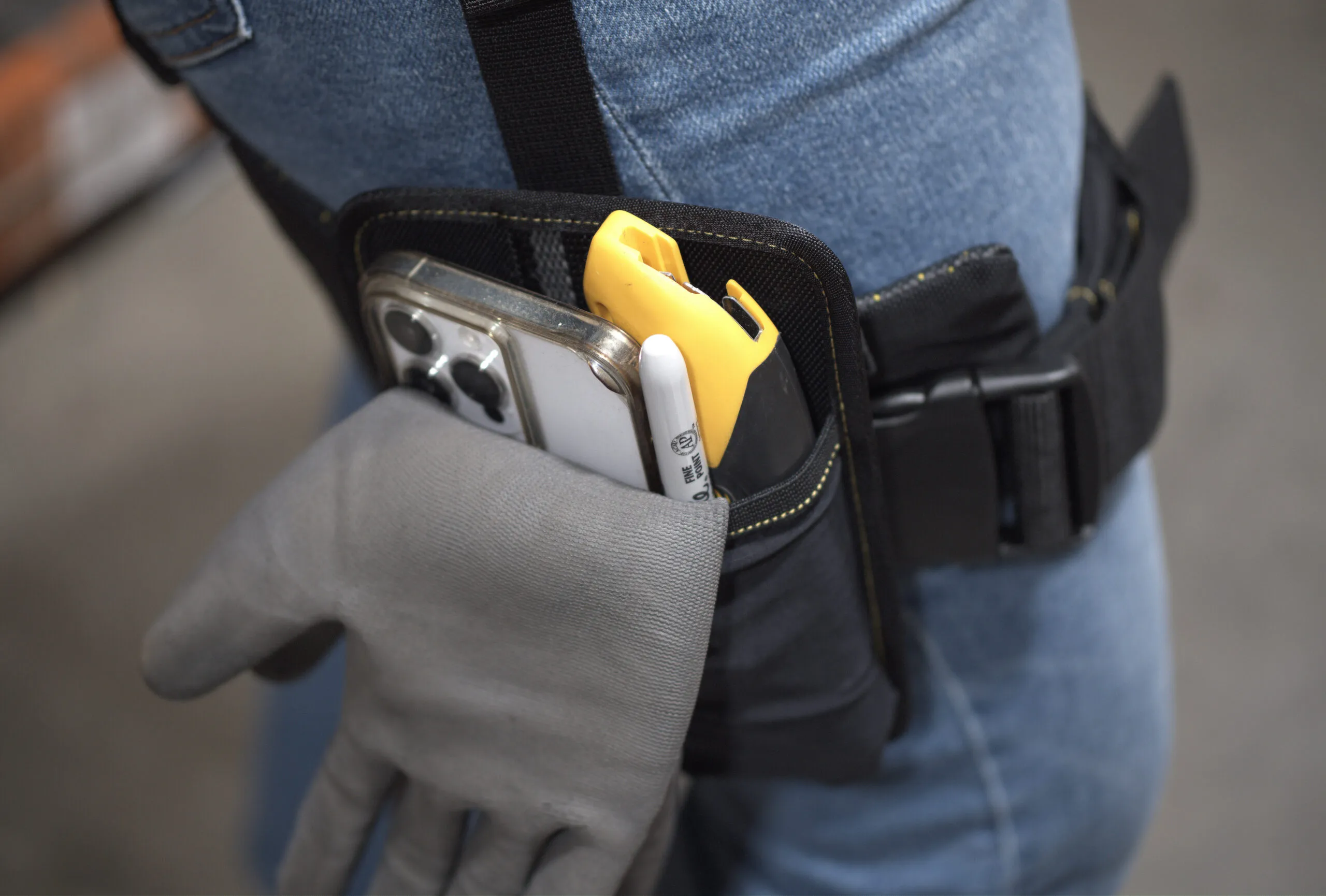 A gloved hand reaching into the Apex 2 hip pocket