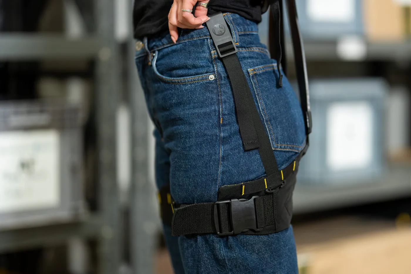 The Apex 2 leg strap buckled around a worker's thigh, with webbing running down from a clip at the waistband